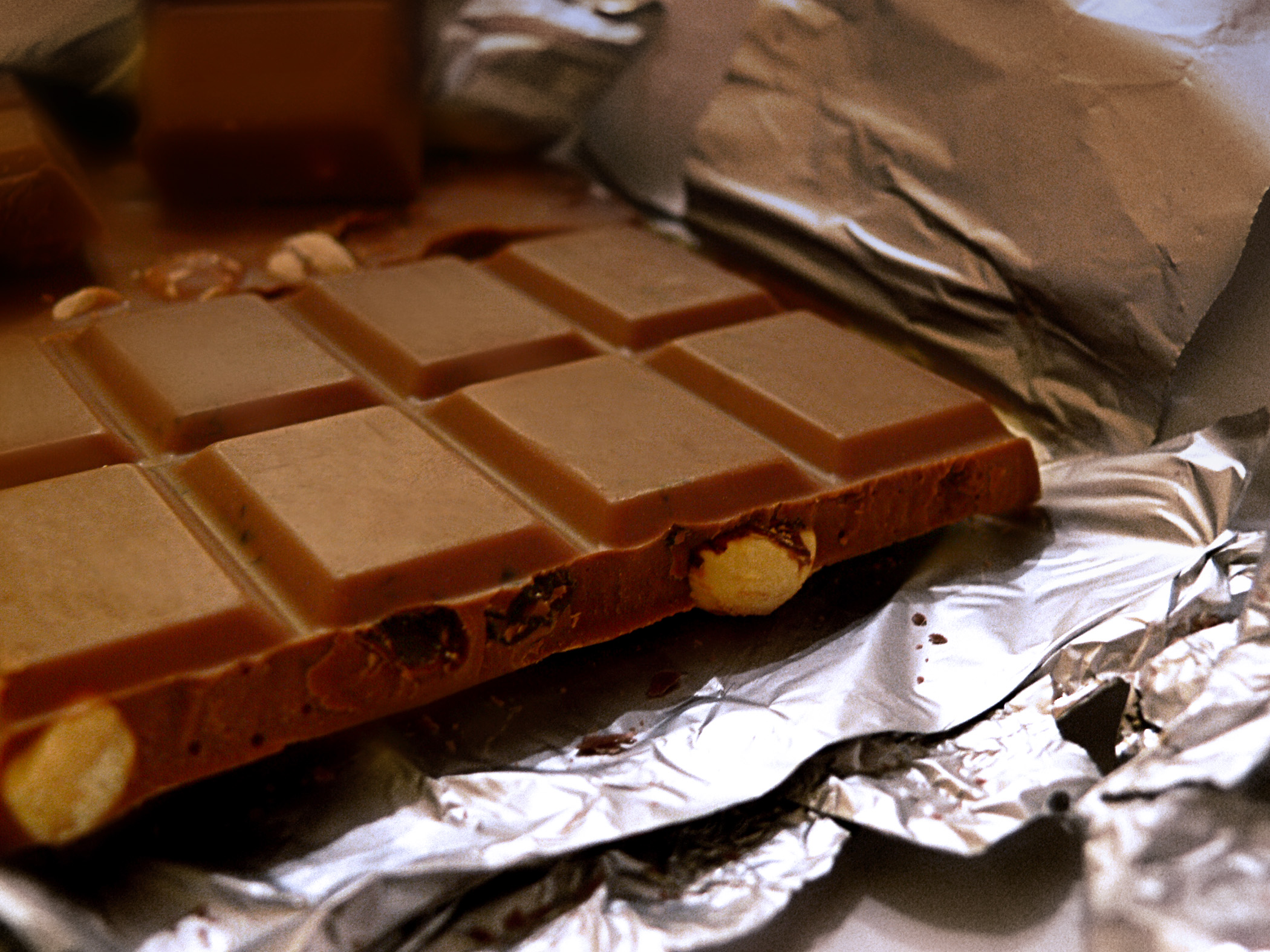 Chocolate bar with nuts on a foil wrapper