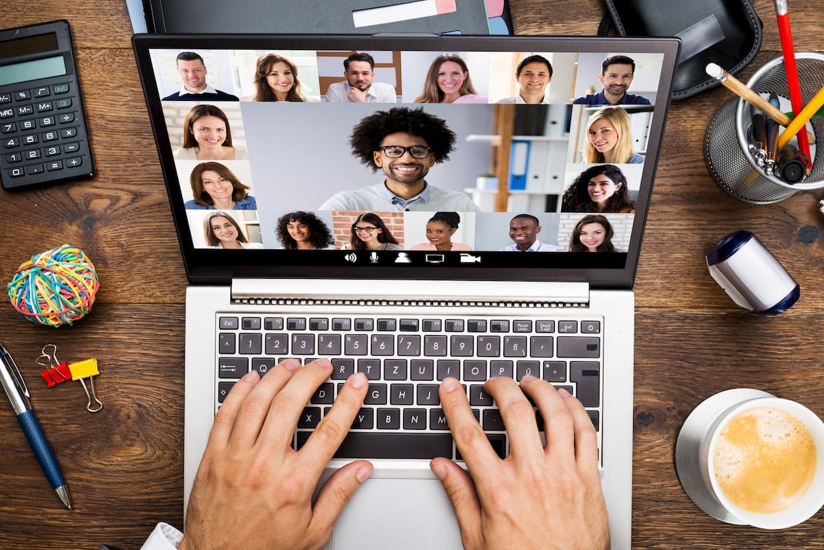 Person typing on a laptop while on a virtual meeting